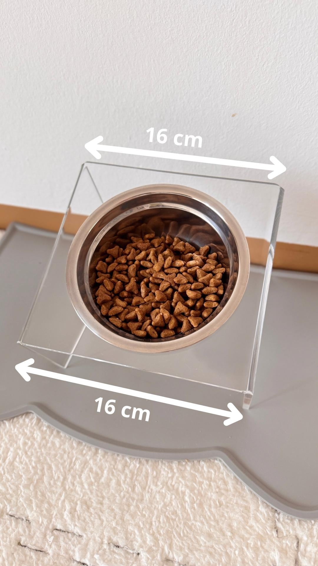 A stand for a bowl for cats and dogs. A holder for a pet bowl. A feeder and bowl included. A stand for pet dishes. Raised stand with bowl